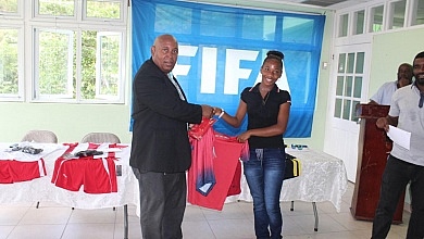 Female Dominica Football player receiving Uniform
