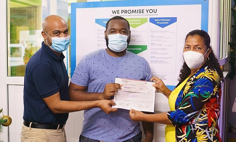Jerrel Joseph (centre), winner of the Home is Where the HeART Is art competition with his prize-winning cheque