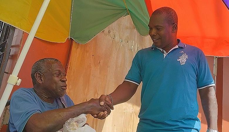 Glenroy Cuffy Shaking Hands With Man