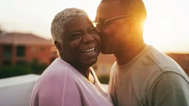 Son Kissing Grandmother on Face