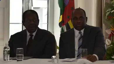 Prime Minister Roosevelt Skerrit sitting with Sir Dennis Byron