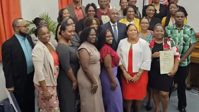 Dr. Irving McIntyre flanked by graduates