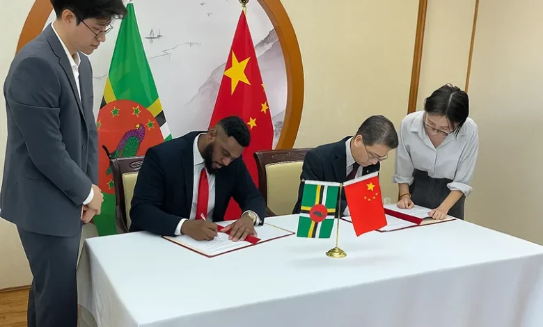 Hon. Cassanni Laville and Chinese Ambassador to Dominica Chu Maoming sign documents at the official signing ceremony