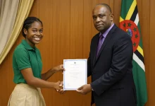 Students, receives her CXC Certificate from the Educational Official from the Ministry of Education in Dominica