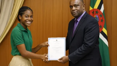 Students, receives her CXC Certificate from the Educational Official from the Ministry of Education in Dominica