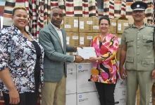 Minister for National Security and Legal Affairs, Hon. Rayburn Blackmoore and his Team Stands with Deputy Resident Representative for the UNDP, Stephanie Ziebell