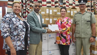 Minister for National Security and Legal Affairs, Hon. Rayburn Blackmoore and his Team Stands with Deputy Resident Representative for the UNDP, Stephanie Ziebell