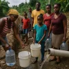 Residents Filling Water Containers in Village