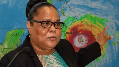 Replica of Octavia Afred Standing in Front and Pointing to Hurricane Melissa heading to Jamaica and Cuba