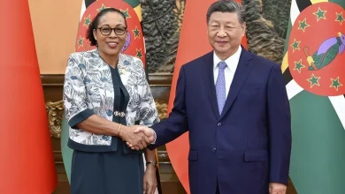 Dominica’s President Sylvanie Burton, shaking hands with Chinese President Xi Jinping. While the flags of Both Countries are in the background