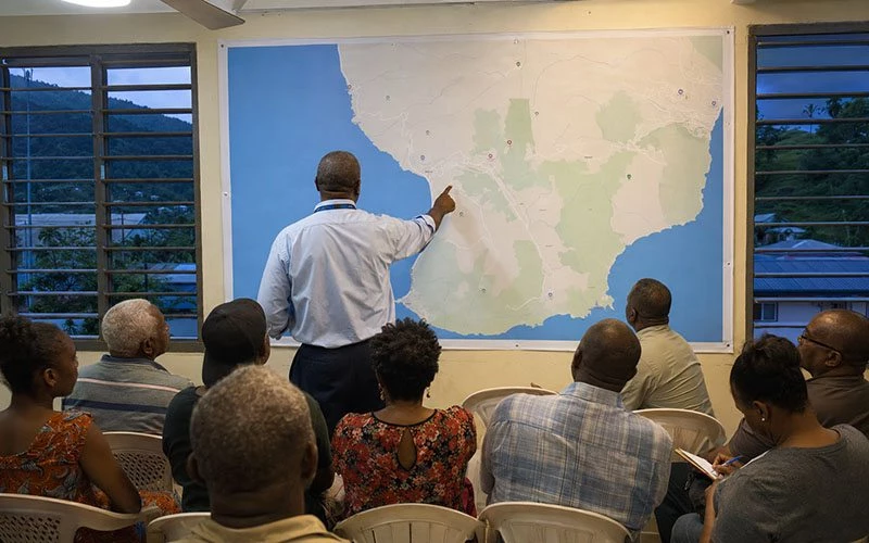ODM representative Carlisle John-Baptiste speaks with residents during an evening volcano-awareness and earth-movement meeting in Gallion, Dominica.